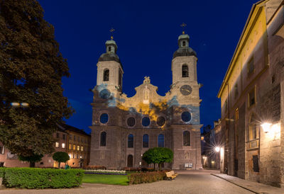 Facade of historic building against sky at night
