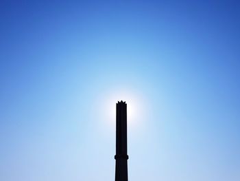 Low angle view of smoke stack against sky