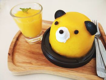 High angle view of yellow drink on table