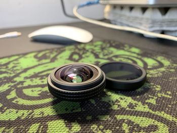 Close-up of camera lens on table