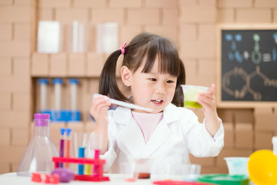 Cute girl experimenting at classroom