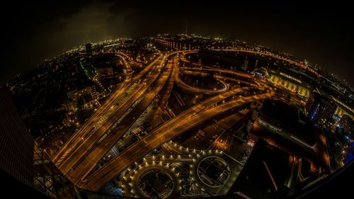 High angle view of city lit up at night