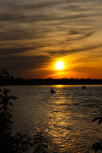 Scenic view of lake at sunset