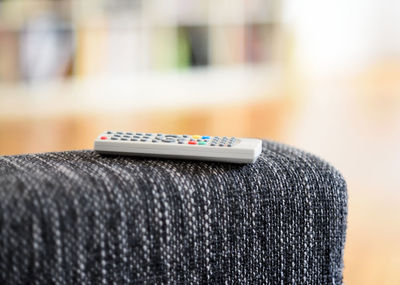 Close-up of remote control on sofa