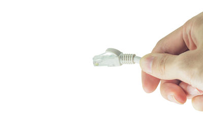 Close-up of man holding camera over white background