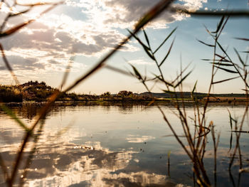 Scenic view of lake against sky at sunset