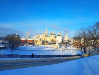 View of buildings against blue sky during winter