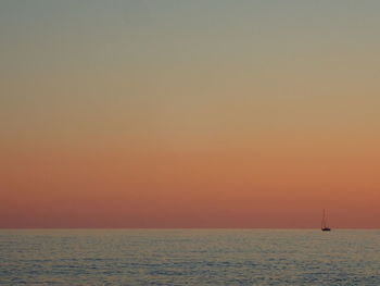 Scenic view of sea against orange sky