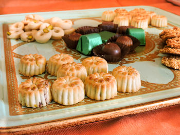 High angle view of cookies with chocolates in tray