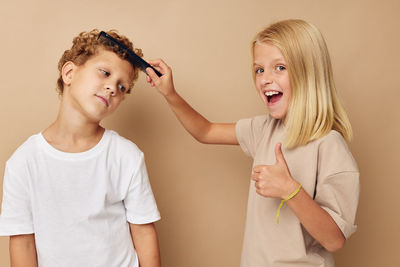 Sister combing brothers hair