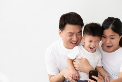 Father and son against white background