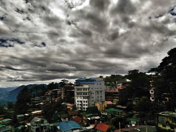 View of residential district against cloudy sky