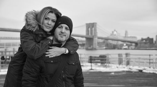 Portrait of couple against brooklyn bridge