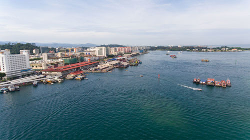 High angle view of sea and buildings against sky