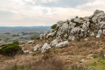 Rock formations on landscape against sky