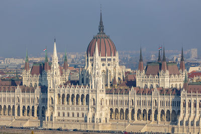 Buildings in city against clear sky