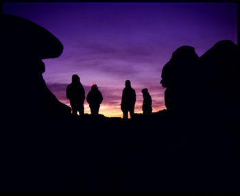 Low angle view of silhouette people against sky during sunset