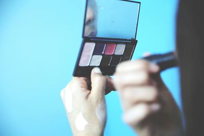Cropped image of woman applying make-up