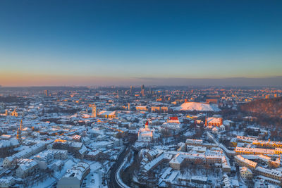 High angle view of illuminated city against sky during winter