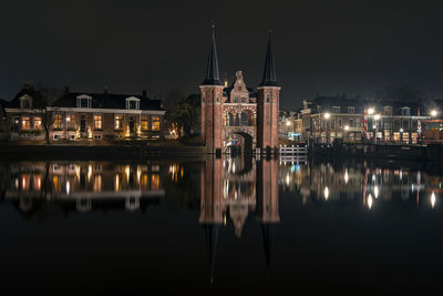 Reflection of illuminated buildings in water at night