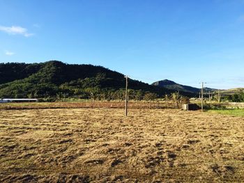 Scenic view of mountains against blue sky