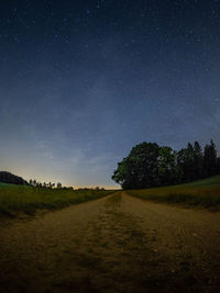 Scenic view of field against sky at night