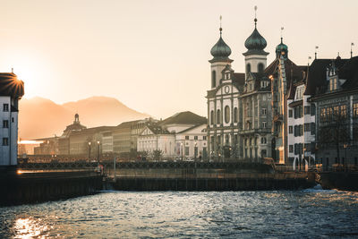 Buildings at waterfront against sky