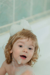 Portrait of cute baby girl in bathroom