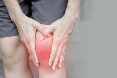 Midsection of person suffering from knee pain