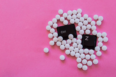 High angle view of heart shape on pink table