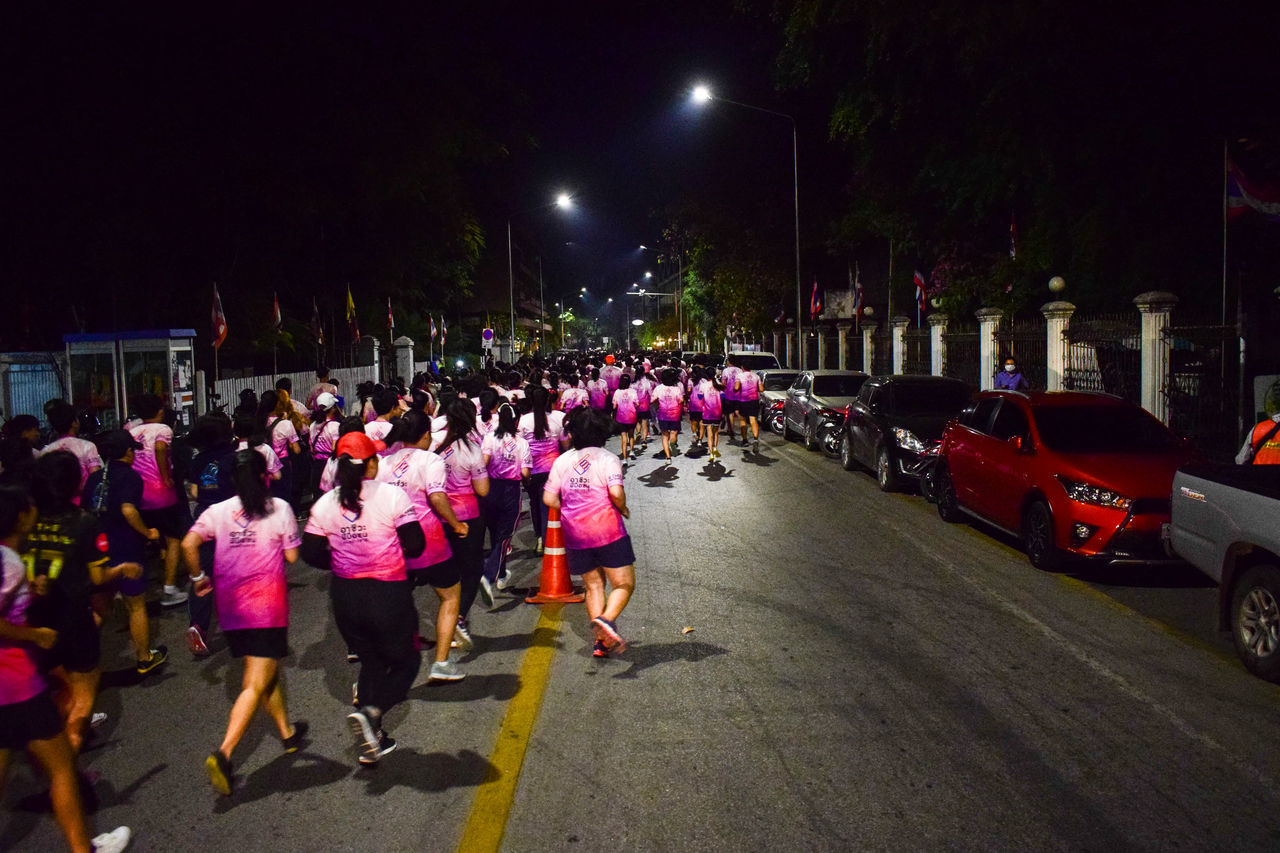 PEOPLE ON STREET AT NIGHT