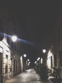 Empty illuminated street lights at night