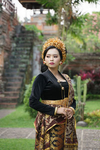 Portrait of young woman standing outdoors