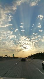 Cars on road against sky