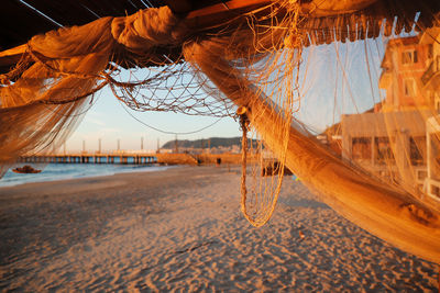 Close-up of rope on beach against sky