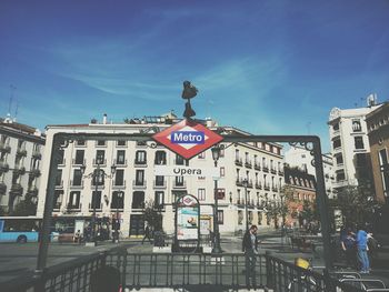 View of city street against blue sky