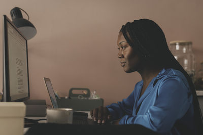 Focused female business professional working at desk in office