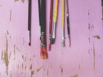 High angle view of paintbrushes on wooden table
