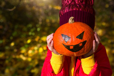 Close-up of girl holding pumpkin