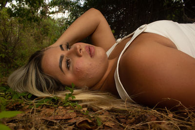 Portrait of woman lying down on land