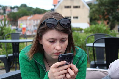 Portrait of young woman using mobile phone