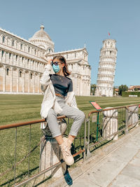 Portrait of woman standing outside building