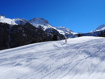 Scenic view of snow covered mountains against clear sky