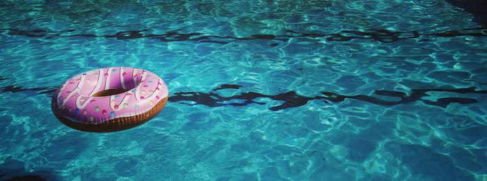 Close-up of inflatable ring over swimming pool