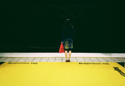 Woman standing in the dark