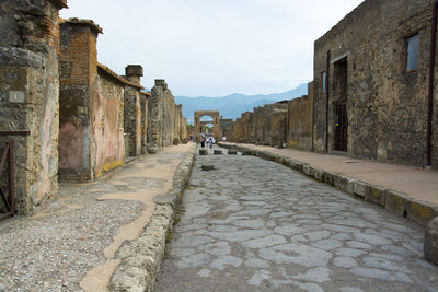 Street amidst buildings against sky