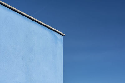 Low angle view of building against clear blue sky