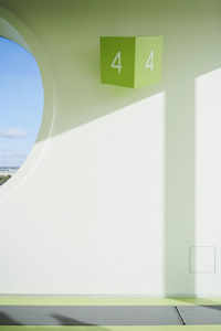 Close-up of arrow sign on wall