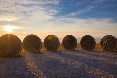 Hay bales on field against sky