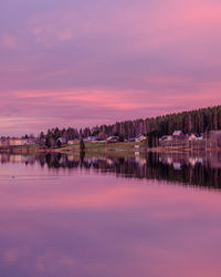 Scenic view of lake against romantic sky at sunset